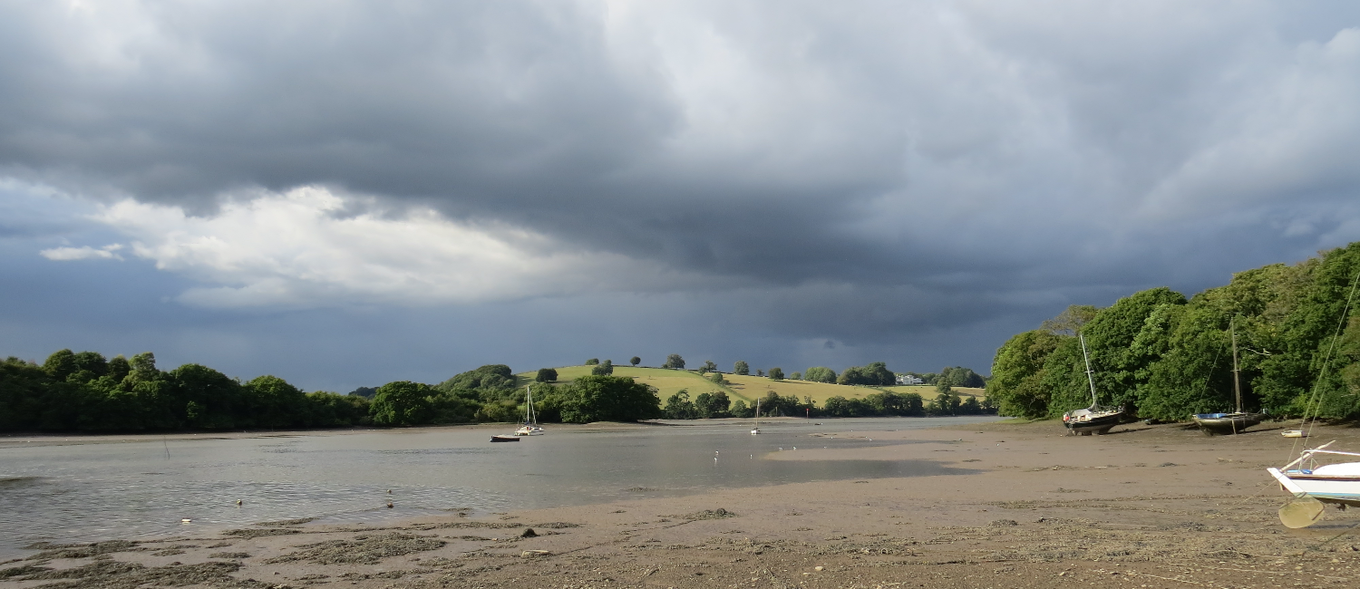 Dark clouds loom over the river Dart